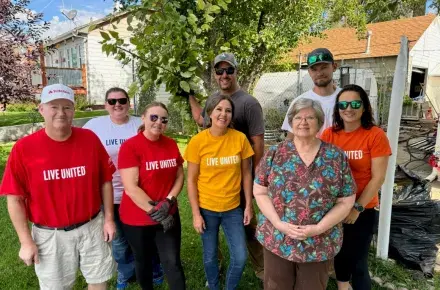 helping hands day volunteers pose with the senior citizen they completed projects for